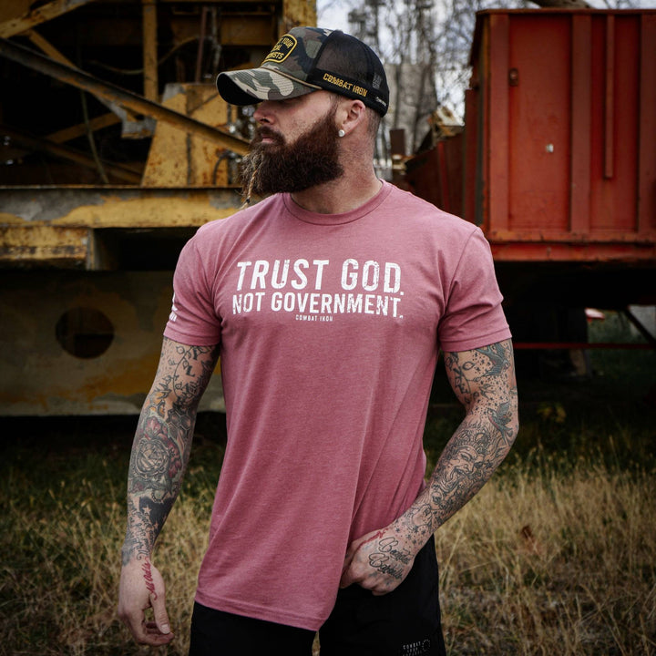 Men’s black t-shirt with the message “Trust God. Not government.” with letters and a American flag on the sleeve #color_muave