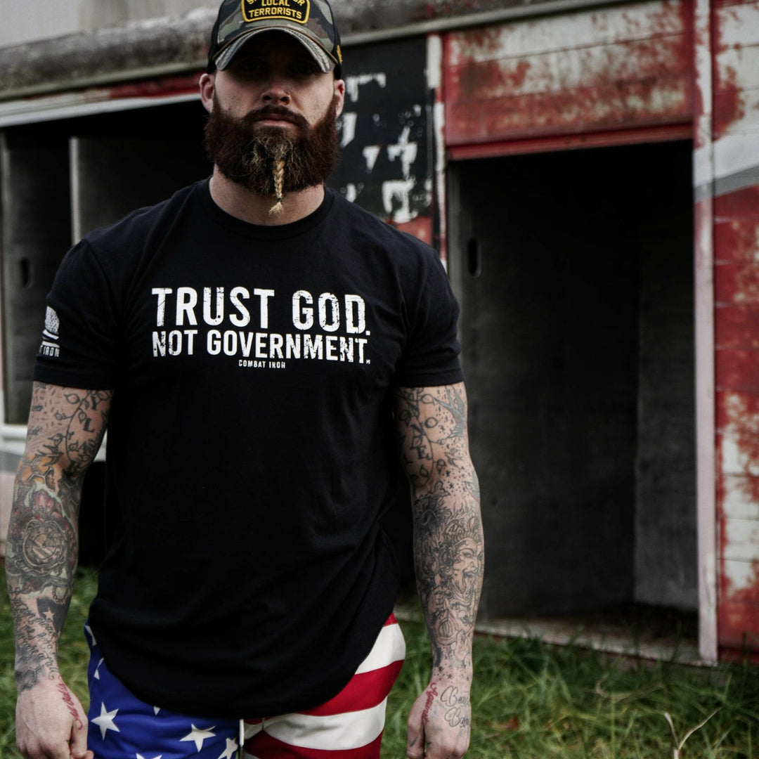 Men’s black t-shirt with the message “Trust God. Not government.” with white letters and a white American flag on the sleeve #color_black