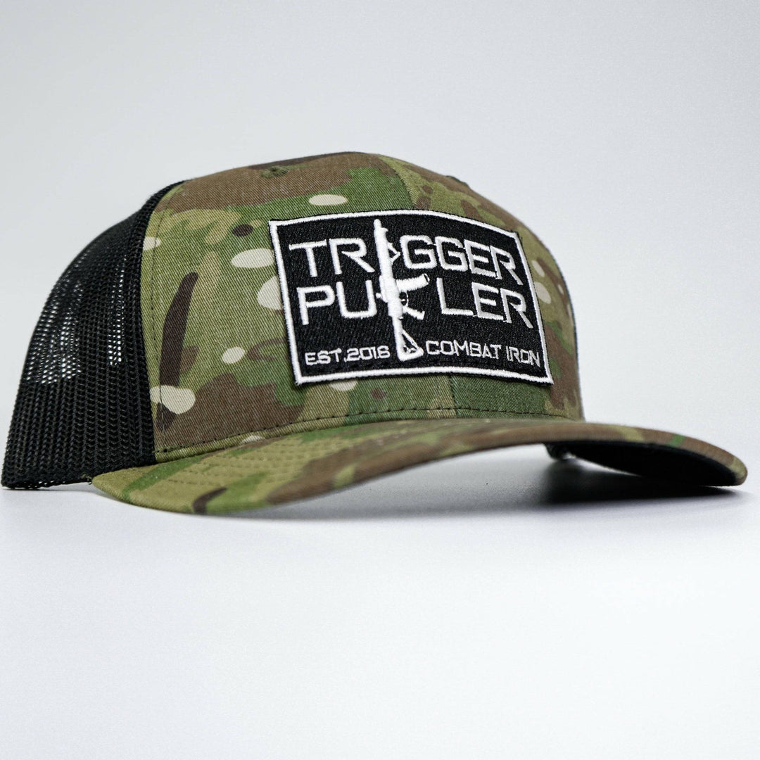 A mid-profile mesh snapback with the words “Trigger puller” on the front in white #color_multicam-black