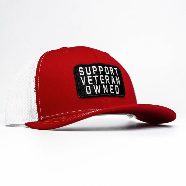 A mid-profile mesh snapback with a patch that says “Support veteran owned” in white letters #color_red-white