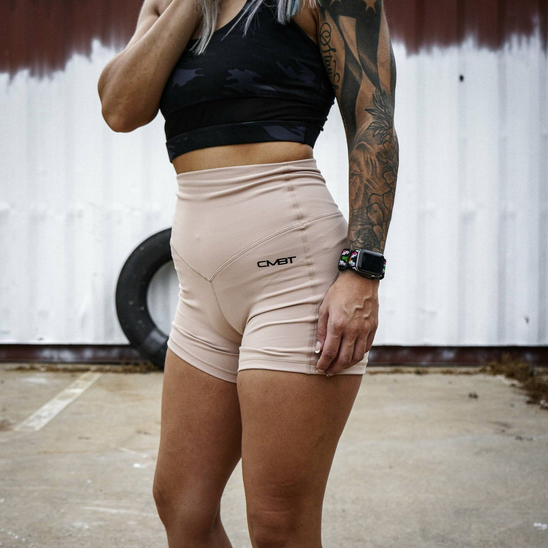 Ladies' luxe high-waisted shorts for women, all tan with the CMBT logo #color_tan