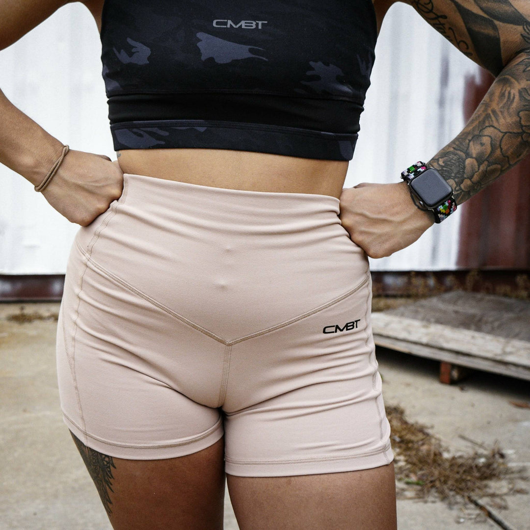 Ladies' luxe high-waisted shorts for women, all tan with the CMBT logo #color_tan