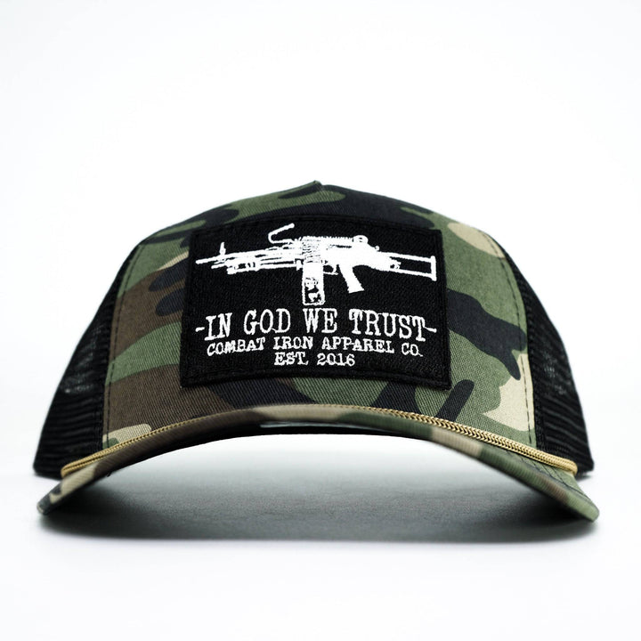 A camo retro rope snapback with a black patch saying “In God we trust” in white letters and an LMG on it #color_bdu-camo-black