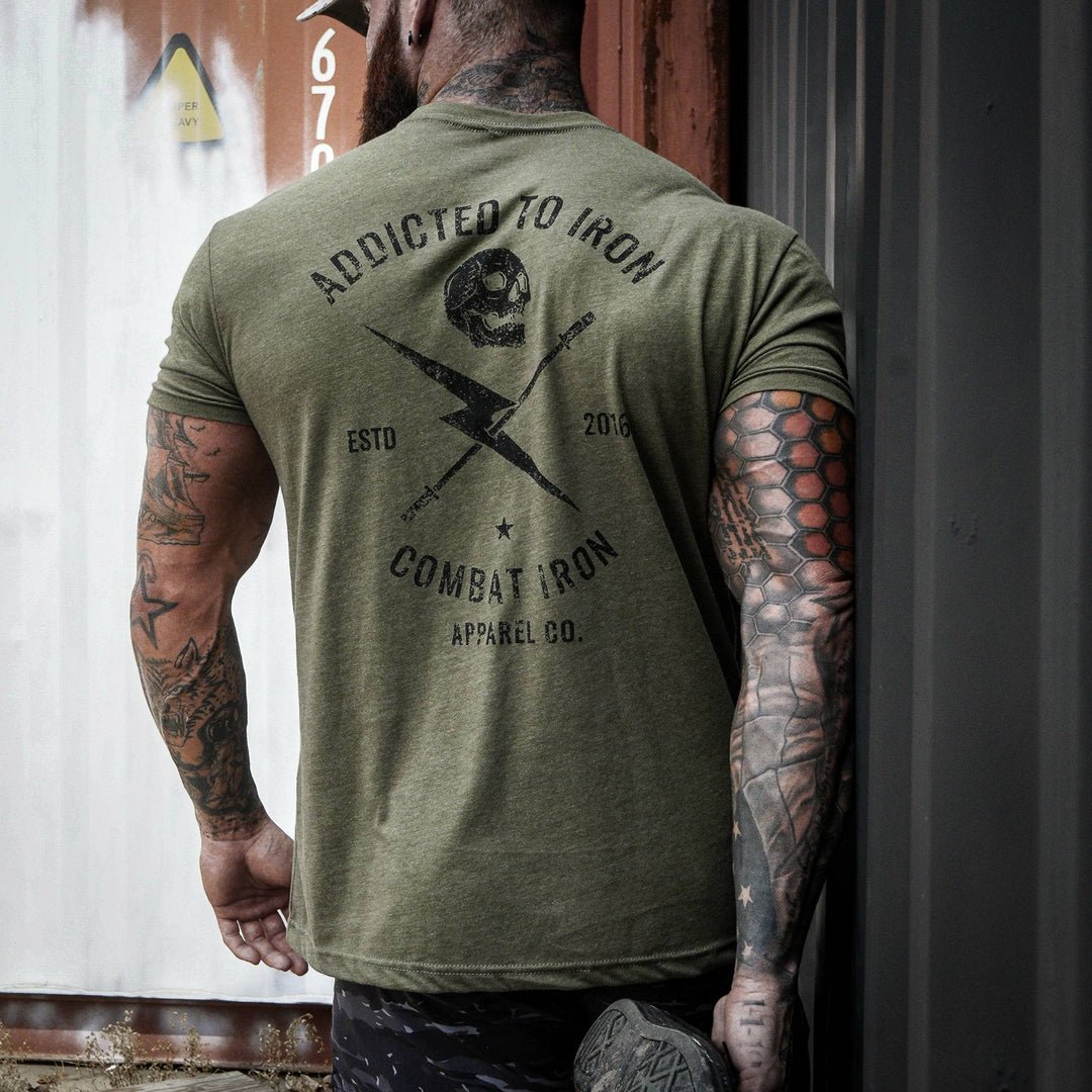 Men’s t-shirt with the print that says “Addicted to iron, combat iron” and a bolt, a barbell, and a skull in the front  #color_military-green