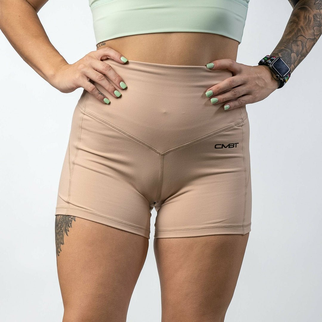 Ladies' luxe high-waisted shorts for women, all tan with the CMBT logo #color_tan