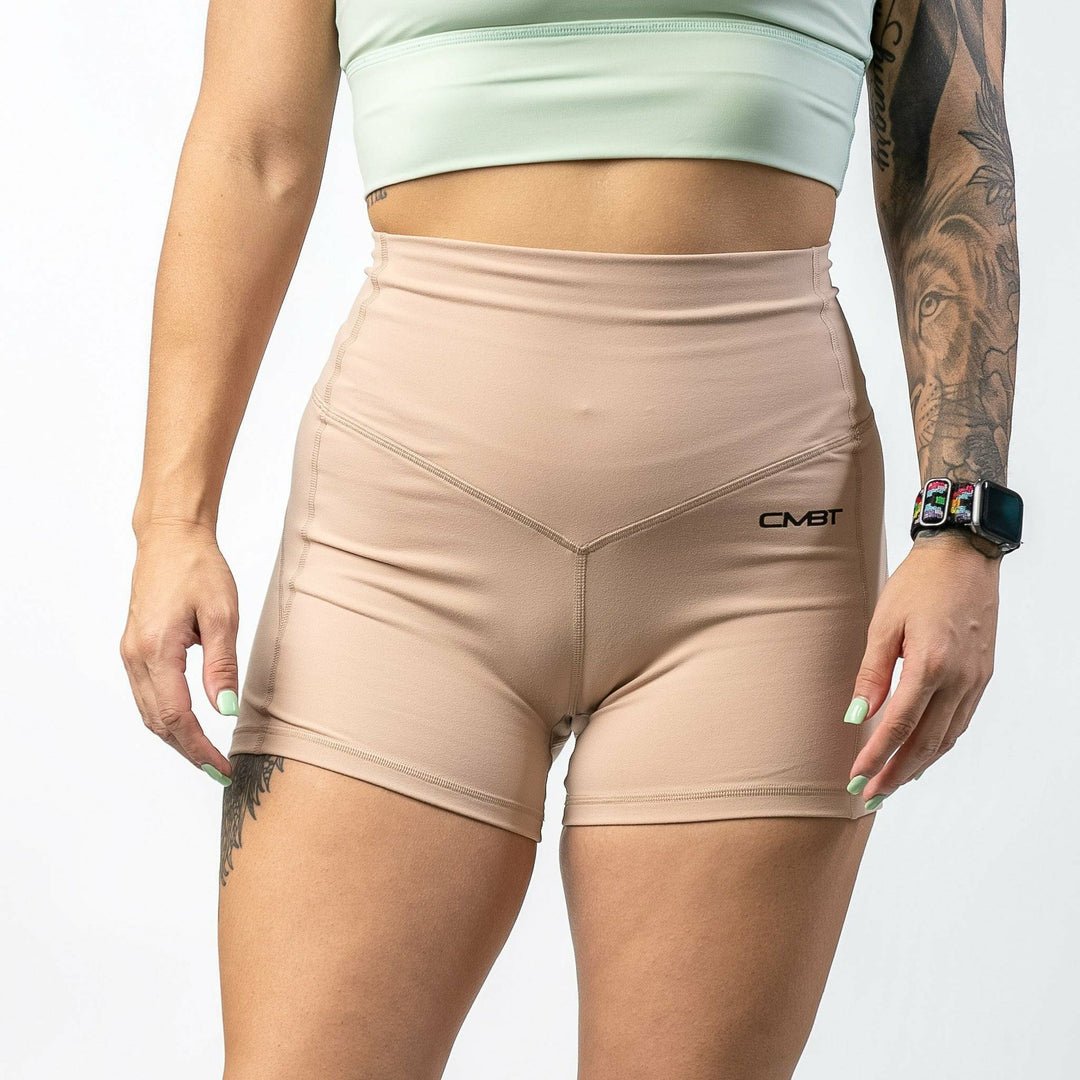 Ladies' luxe high-waisted shorts for women, all tan with the CMBT logo #color_tan