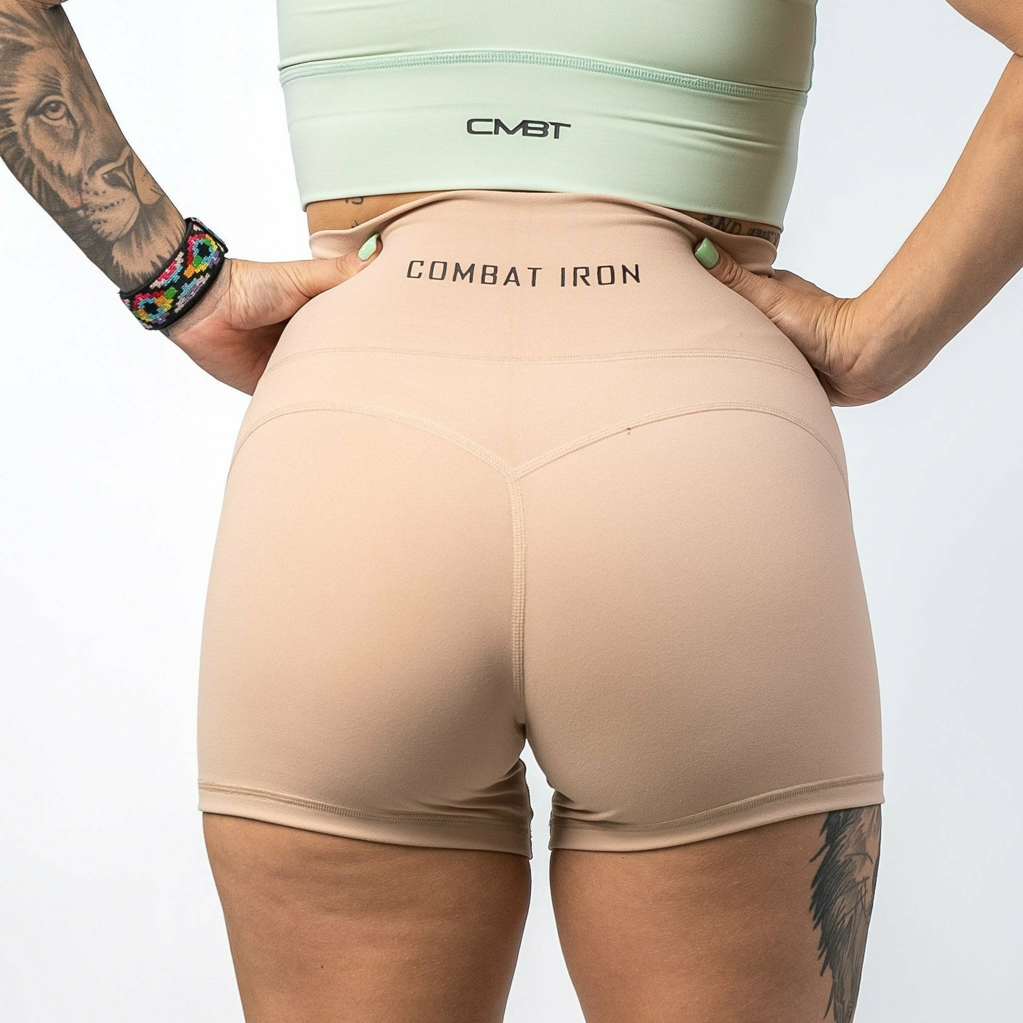 Ladies' luxe high-waisted shorts for women, all tan with the CMBT logo #color_tan